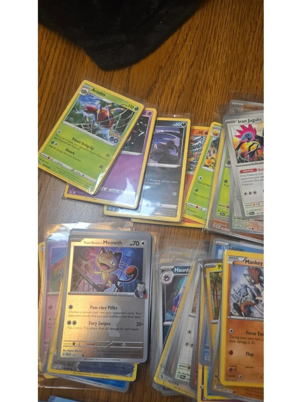 Bulk Lot of Mixed Pokemon Trading Cards with Sleeves and Storage Box
